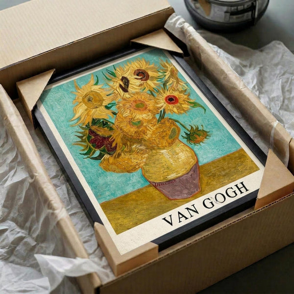 May include: Framed reproduction of van Gogh's iconic sunflowers painting showing yellow blooms in a vase against turquoise background, displayed in black frame within opened cardboard shipping box surrounded by protective white tissue paper on neutral surface.