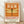 May include: A framed vintage-style poster with orange background featuring a detailed dragonfly illustration with transparent wings and segmented body. Japanese text appears at top, with "DRAGONFLY" and "KYOTO SCIENCE MUSEUM 2005年4月16日" below. The wooden-framed print leans against a white wall on light wooden flooring with natural lighting casting soft shadows.