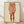 May include: Framed reproduction of an Egon Schiele drawing showing the lower torso and legs of a standing figure in red and sepia tones on cream paper, displayed in a light wood frame against white walls on wooden flooring with natural window light casting shadows.