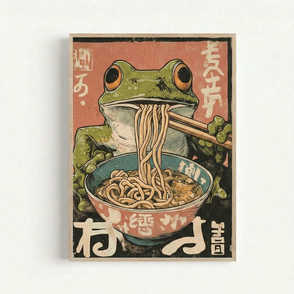 A vintage-style Japanese poster featuring a green frog with orange eyes eating noodles from a teal and coral bowl using chopsticks. The artwork has a weathered, distressed appearance with Japanese characters on a salmon-pink background. The illustration uses muted earth tones and has the aesthetic of retro Japanese advertising art. The poster is displayed in a simple light wood frame against a white wall.