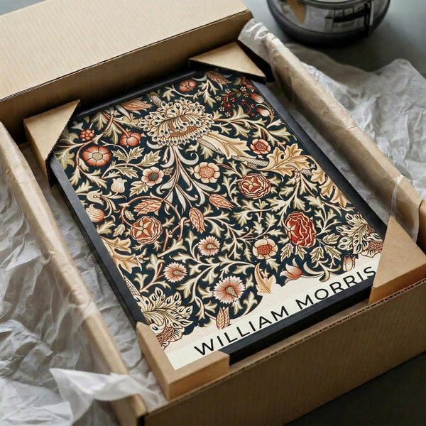 May include: Ornate floral poster print in shipping box with tissue paper wrapping. Features intricate Victorian-style botanical design with roses, chrysanthemums, and flowing foliage in rich burgundy, gold, and cream tones against dark background. Black-framed artwork shown nestled in brown cardboard packaging on white surface with soft natural lighting.