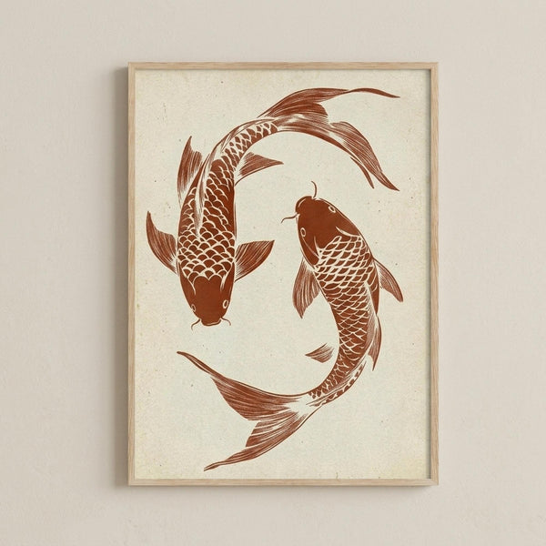 May include: Two koi fish arranged in a circular yin-yang pattern, printed in warm reddish-brown ink on cream-colored textured paper. The fish feature detailed scales and flowing fins, displayed in a light wooden frame against a neutral beige wall. The artwork has a minimalist, Japanese-inspired aesthetic with visible paper texture and natural fiber specks.