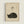May include: Framed vintage-style Japanese art print featuring a curled up sleeping black cat silhouette on cream textured paper background. Black brushstroke Japanese calligraphy characters appear above the cat. Light wooden frame displayed against white wall with subtle shadow.