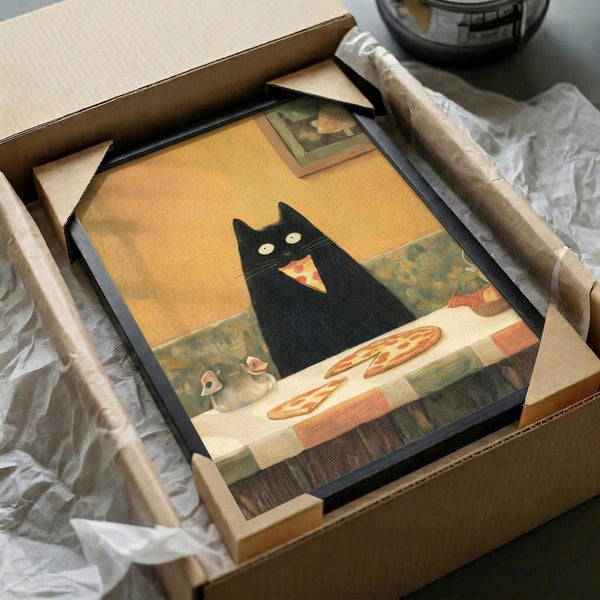 May include: Framed poster print in black frame being unboxed from cardboard shipping box with white tissue paper. Art shows black cat with glowing eyes eating pizza slice at table with whole pizza nearby and small mouse. Warm yellow-orange background creates cozy indoor scene. Frame appears medium-sized compared to protective packaging materials.