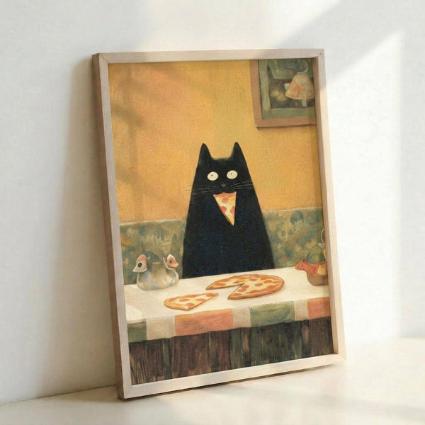 May include: Framed art print leaning against white wall showing a whimsical black cat with wide yellow eyes eating a slice of pizza in a cozy kitchen setting. The illustration features warm yellow walls, checkered tablecloth, salt and pepper shakers, and a small framed picture in the background. Light wooden frame surrounds the artwork in this styled room mockup.