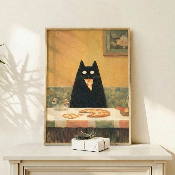 May include: Framed artwork displayed on white wooden console table showing black cat with wide yellow eyes eating pizza slice at checkered table in warm kitchen setting with yellow walls and framed art. White gift box with evergreen sprig and white ceramic vase with dried palm fronds styled nearby.