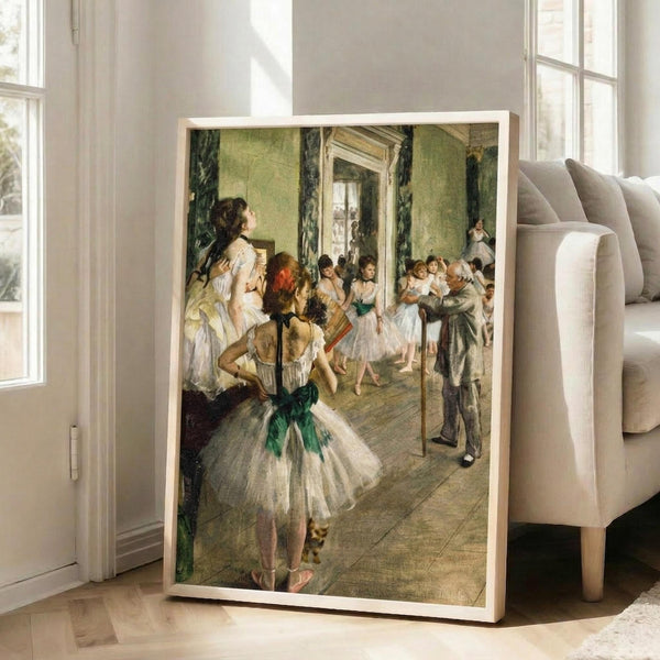 May include: Framed reproduction of Degas ballet painting showing dancers in white tutus with green sashes in ornate interior room with pale green walls, displayed leaning against beige upholstered sofa in bright modern living room with white walls and large windows