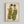May include: Framed art print hanging on white wall showing two elongated figures in green and brown garments with dark hair, drawn in expressive line work characteristic of early 20th century Austrian art. The artwork features earth-tone colors on cream paper within a light wood frame.