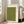 May include: Large framed artwork with light wood frame leaning against white wall next to beige upholstered chair. Print features textured olive green background with three simple black bird silhouettes in flight and vertical column of Japanese calligraphy characters on cream-colored right margin. Natural lighting from nearby windows creates soft shadows on hardwood floor.