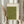 May include: Person in cream ruffled blouse holding framed artwork against white curtained window, with dried wheat stems. Green textured poster features minimalist black line drawings of flying birds and vertical Japanese calligraphy text on cream background in light wood frame.