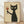May include: Framed poster print featuring a black cat with white eyes holding a wine glass filled with red wine. The cat has a textured, sketchy appearance against a cream background. Wooden frame sits on light wooden flooring against white wall with natural lighting casting shadows.