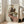 May include: Framed reproduction of an expressionist drawing showing two figures in an intimate embrace, featuring muted earth tones with pops of coral and green. The artwork displays characteristic angular lines and emotional intensity, housed in a light wood frame leaning against white walls in a bright modern living room with beige furniture and large windows.