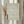 May include: Framed wall art displaying an intricate repeating pattern of flowing ocean waves in traditional Japanese style, rendered in sage green lines on cream background with red vertical Japanese characters in lower left corner. Light wood frame hangs on white wall beside dried pampas grass stems creating warm, minimalist home decor scene with natural lighting.