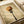 May include: Canvas print displaying spaghetti noodles twirled around a black fork against a muted beige background with vintage texture, shown in white matting alongside white ribbon on a light surface