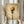 May include: Person in cream sweater holding framed artwork showing pasta twirled on a fork against warm beige textured background, displayed in light wood frame in bright room with dried pampas grass and white curtains