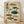 May include: Framed vintage-style Japanese scientific illustration poster leaning against white wall on light wood floor. The beige-toned print features eight detailed pufferfish in various colors including brown, teal, and green, with Japanese calligraphy and red stamps. Natural wood frame surrounds the educational chart showing different fugu species with anatomical precision in traditional ukiyo-e art style.