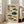 May include: Framed vintage-style Japanese scientific illustration featuring eight detailed pufferfish specimens in various colors including brown, teal, and green on aged beige background with Japanese calligraphy and red stamps, displayed in light wooden frame leaning against white wall next to beige upholstered chair in bright room with large windows