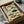 May include: Framed vintage-style educational chart displaying eight illustrated pufferfish in various colors including brown, green, and teal against cream background with Japanese text and red seals, shown in black frame nestled in cardboard shipping box with white tissue paper on wooden surface