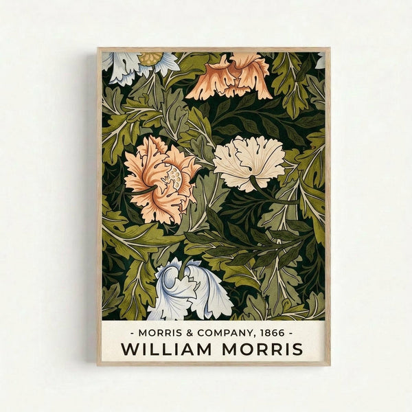 Vintage botanical art print featuring ornate flowers and foliage in rich greens, soft peach, and cream tones with intricate William Morris-style decorative patterns. The artwork is displayed in a light wooden frame against a white wall, showing the detailed leaf and floral motifs characteristic of Victorian design with flowing, organic shapes and elegant botanical illustrations.