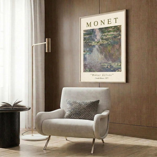 May include: Cream-colored framed art print featuring Claude Monet's impressionist water lilies painting in soft blues, greens, and purples, hung on wood-paneled wall above beige upholstered armchair with geometric patterned pillow. Modern reading nook with brass floor lamp, dark round side table with open book, and natural lighting from window with curtains.