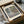 May include: Framed art print of Monet's Water Lilies painting showing impressionist pond scene with soft greens, purples, and blues, displayed in dark frame on cream mat. Wooden frame pieces and white tissue paper visible in brown cardboard box packaging on neutral surface.