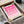 May include: Framed poster with geometric pink circular and semi-circular shapes arranged in a grid pattern on cream background. Text reads "BAUHAUS 1919-1933 SCHOOL OF ARTS & CRAFTS" at bottom. Black frame partially unwrapped from brown cardboard packaging with white tissue paper. Wooden rolling pin visible beside frame on white surface.
