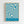 May include: Framed poster with flowing blue and cream swirled pattern hanging on white textured wall. Light wood frame surrounds abstract wavy design with "BAUHAUS AUSSTELLUNG Juli-Sept 1923" text at bottom in clean sans-serif font against solid blue background.