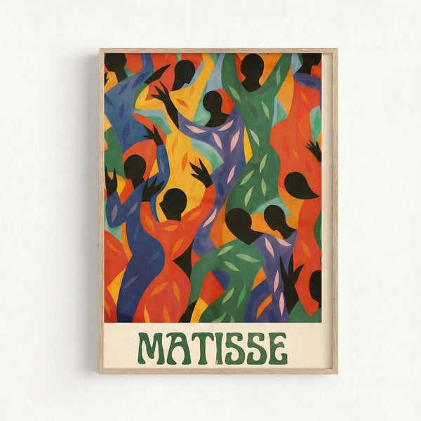 Colorful abstract artwork featuring silhouetted dancing figures in vibrant blues, oranges, greens, and yellows with flowing, organic shapes. The composition shows multiple human forms with raised arms in dynamic movement against swirling colored backgrounds. Below the artwork is green text reading "MATISSE" on a cream background. The print is displayed in a light wooden frame against a white wall.