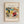 May include: Framed abstract art print in light wood frame hanging on white wall. Colorful expressionist painting with flowing organic shapes in vibrant yellows, reds, blues, and greens. Features swirling brushstrokes, curved forms, and dynamic movement typical of early modern art style. White matting surrounds the artwork with artist name printed below the image.