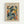 Framed art poster featuring an abstract figure in Matisse's cut-out style, with flowing blue and teal shapes forming a dancing human form against colorful geometric background of yellow, orange, and red. The word "MATISSE" appears at top, "ART POSTER" at bottom. Natural wood frame with beige matting, displayed against white wall.