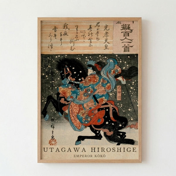Framed Japanese woodblock print showing a dramatic scene with figures in colorful robes amid swirling snow or petals against a dark background. The artwork features traditional ukiyo-e style with bold blues, oranges, and reds. Japanese calligraphy appears at the top and sides of the composition. The print is displayed in a light wooden frame against a white wall.