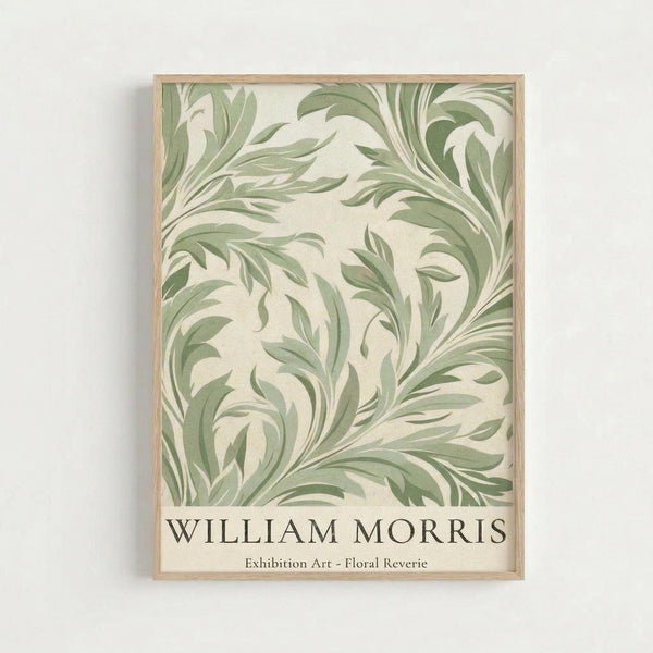 May include: Framed botanical art print with flowing sage green leaf patterns on cream background, displayed in light wood frame against white wall. Features elegant swirling foliage motifs in William Morris style with exhibition text at bottom.