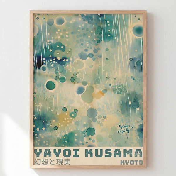 Framed poster with abstract design featuring scattered circles and dots in teal, green, and cream tones with vertical drip effects. Text reads "YAYOI KUSAMA" with Japanese characters and "KYOTO" below. Light wood frame against white wall background.