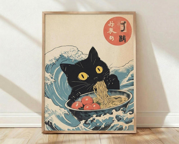 May include: Framed poster print displayed against white wall on wooden floor. Art features black cat with yellow eyes eating ramen from bowl, surrounded by stylized blue ocean waves in traditional Japanese woodblock print style. Noodles hang from cat's mouth, red circular elements visible in bowl and upper corner with Japanese text. Cream background with natural wood frame.