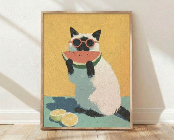 May include: Framed artwork leaning against white wall on wooden floor, showing a cream and dark brown Siamese cat wearing coral sunglasses and holding a watermelon slice. The cat sits on a mint green surface with lemon slices nearby, painted in warm yellows and soft pastels with visible brushstroke texture in a light wood frame.