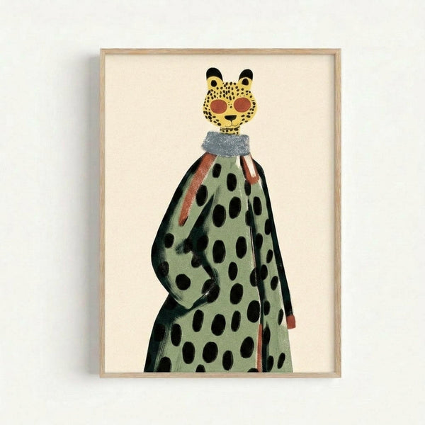 Whimsical illustration of a leopard wearing sunglasses and a polka dot coat in sage green with black spots and coral stripes. The leopard has a yellow spotted face with black ears and coral-colored round sunglasses. A blue collar or scarf is visible at the neck. The artwork is displayed in a light wood frame against a cream background, mounted on a white wall.