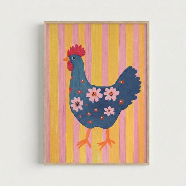 Framed folk art illustration of a blue hen with red comb and wattles, decorated with pink flowers and small red dots across its body. The chicken has orange legs and is displayed against a background of vertical yellow and pink stripes. The artwork is mounted in a light wood frame and shown against a white wall.