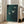 May include: Large framed art print with deep teal-green textured background featuring three white birds in flight, displayed in light wood frame leaning against white wall next to beige upholstered chair in bright, minimalist living room with tall windows and hardwood floors.