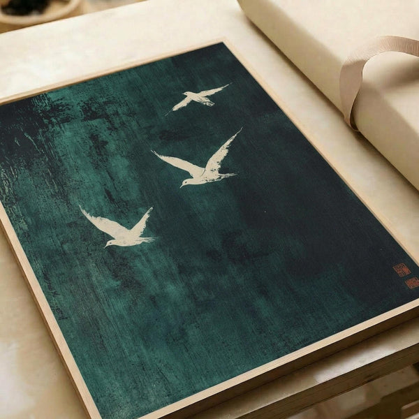 May include: Japanese-style ink print featuring three white seagulls in flight against a textured teal-green background with weathered, brushstroke effects. The artwork displays traditional Asian aesthetic with red seal stamps in the corner. Print shown flat on white paper with rolled paper tubes nearby, demonstrating the poster's size and matte finish.