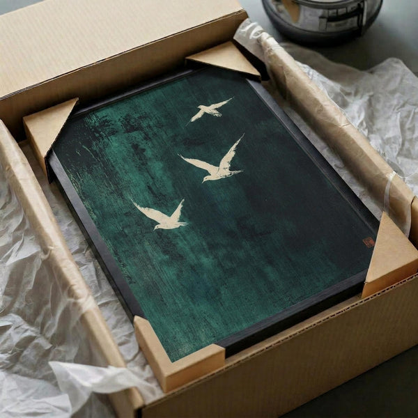 Framed artwork featuring three white birds in flight against a dark teal green textured background with weathered, distressed effects. The piece has an Asian-inspired minimalist aesthetic and is carefully packaged in a cardboard box with protective wrapping materials and wooden corner guards.