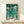 Impressionist watercolor art print depicting a tranquil garden pond with pale yellow and pink flowers reflected in calm teal water, evoking a contemplative mood.