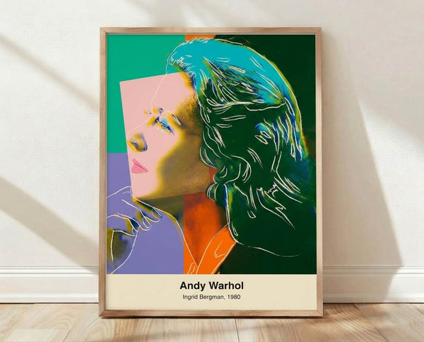 Pop art portrait of Ingrid Bergman in vibrant magenta, cyan, and yellow tones with black and white accents, framed poster on wall.