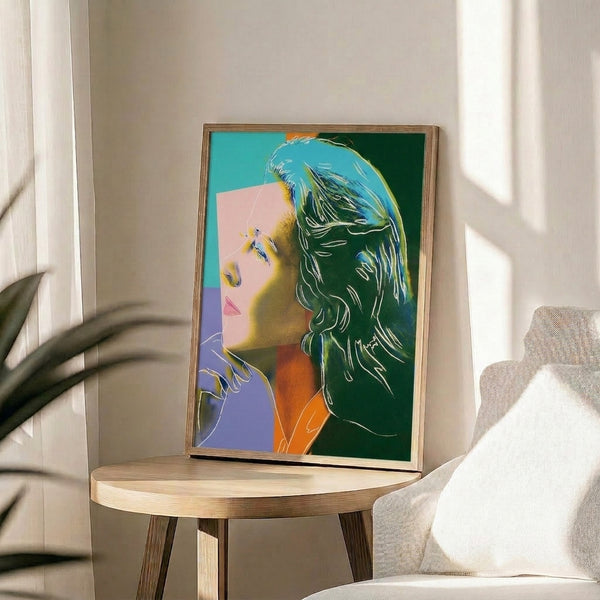 Warhol-inspired pop art portrait showing Ingrid Bergman with striking color combinations and flattened graphic forms framed on a wall.