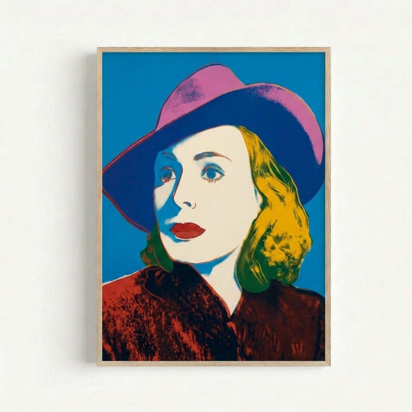 Framed Warhol-style pop art print featuring Ingrid Bergman in a hat with bold, saturated color blocks and high contrast.