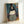 Inheritance poster displaying a haunting faceless portrait in watercolor style, dominated by cool dark tones and introspective mood, suitable for contemporary gallery or bedroom wall decor.