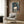 Inheritance portrait poster in watercolor expressionism, depicting an abstracted human form shrouded in shadow and psychological depth through a sophisticated dark color palette.