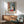 Contemporary framed art featuring a tranquil Nice-inspired interior with blue, ochre, and warm neutrals, evoking leisurely Mediterranean living through impressionist techniques.