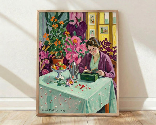 Framed art print of a young girl absorbed in reading, rendered in Matisse's characteristic bold colors and simplified forms with warm oranges, greens, and blues creating a serene domestic scene.