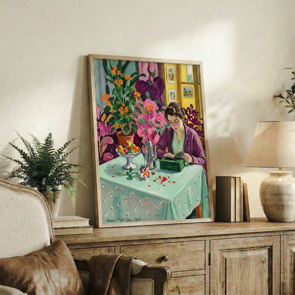 Framed artwork depicting a girl reading in an elegantly composed domestic interior, rendered in saturated colors and simplified shapes that emphasize calm focus and literary engagement.