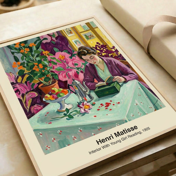 Art print framed on wall depicting a girl lost in a book within a luminous, contemplative interior rendered in vivid yellows, blues, reds, and greens.